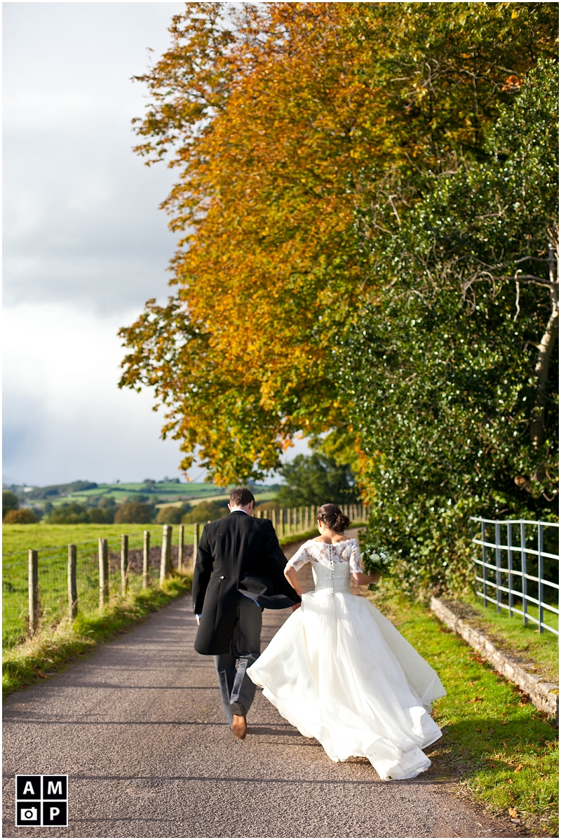 "bride-and-groom-walking-down-a-country-lane"