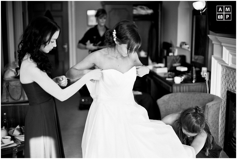 "bride-getting-dressed-in-her-wedding-dress"