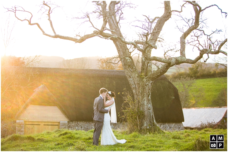 "Sunset-couple-photos-with-a-pear-tree-Great-Barn-Devon"