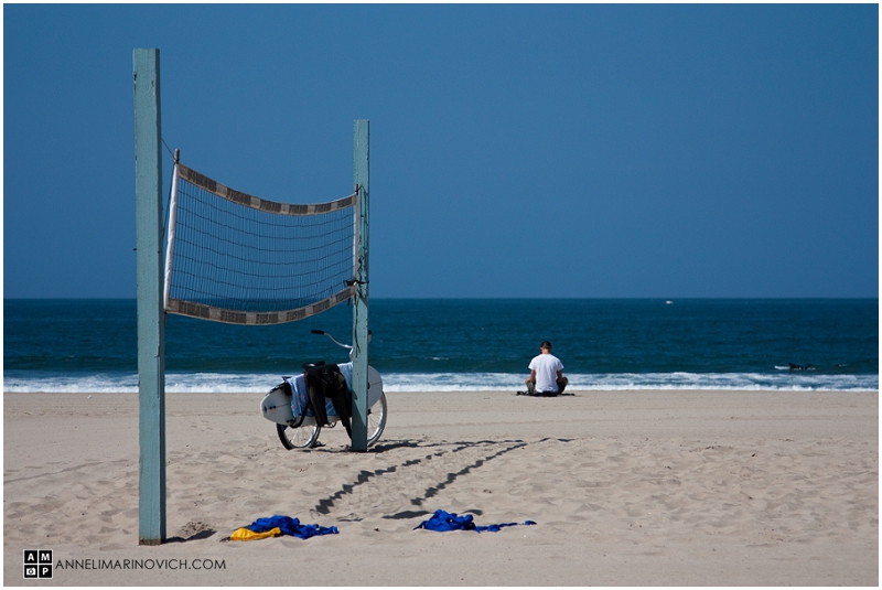 "man-meditating-on-Venice-Beach-california"