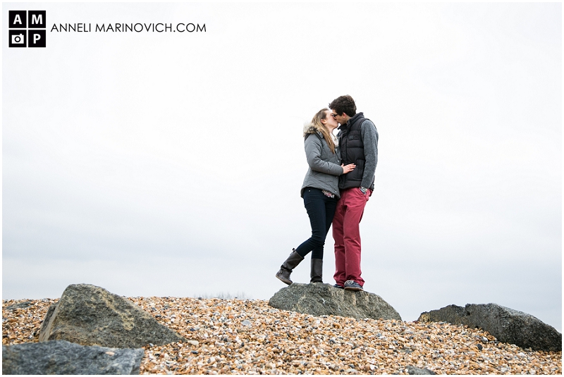 "couple-kissing-on-Shoreham-beach-boulders"