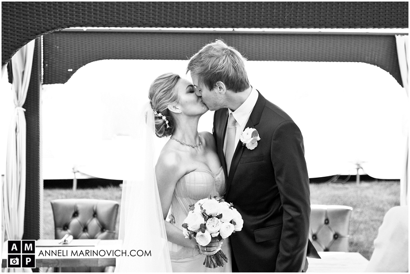 "bride-and-groom-kissing-at-outdoor-wedding-ceremony-Berkshire"