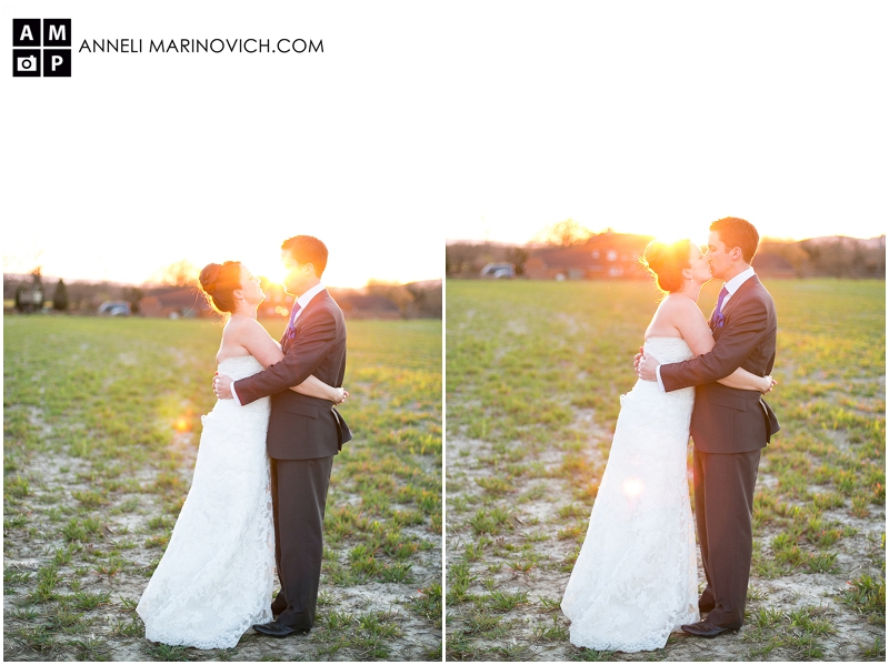 "bride-and-groom-kissing-in-a-field-at-sunset"