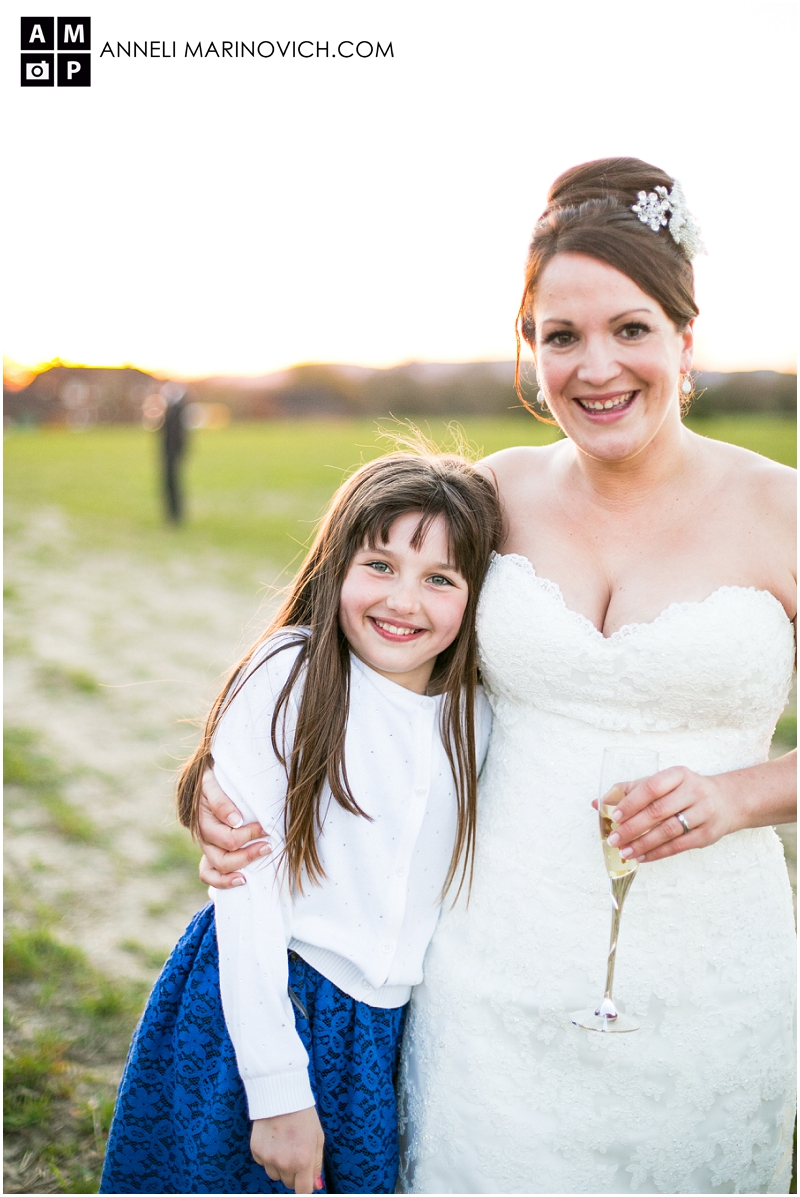 "bride-and-niece-in-a-field-at-sunset"