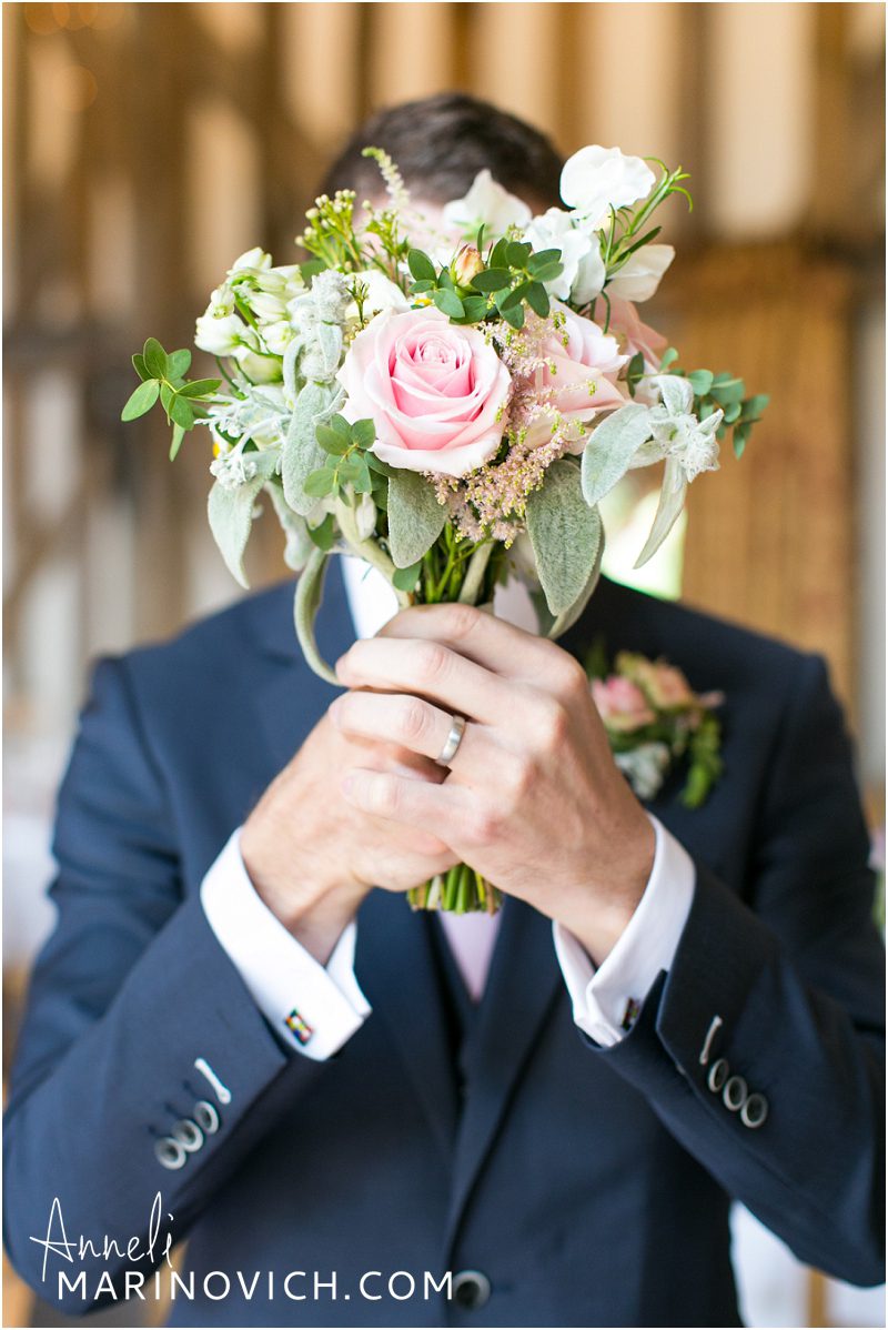 "Groom-holding-a-rustic-pink-rose-wedding-bouquet"