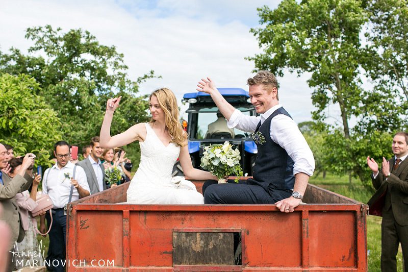 "Bride-and-groom-on-a-tractor-Somerset-wedding"