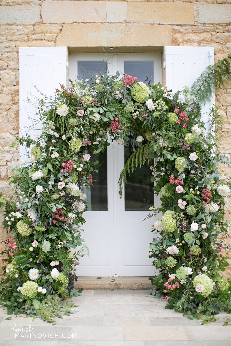 "Chateau-de-Redon-outdoor-wedding-ceremony-floral-arch"