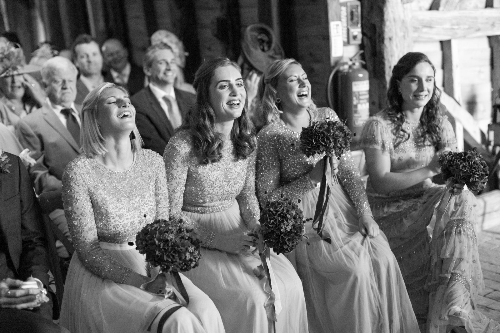 Bridesmaids laughing during the wedding ceremony