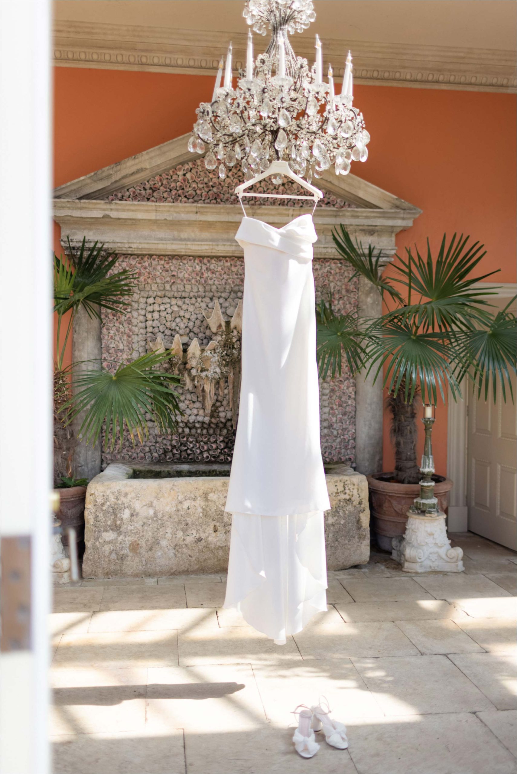 Wedding dress hanging from a chandelier at Euridge Manor