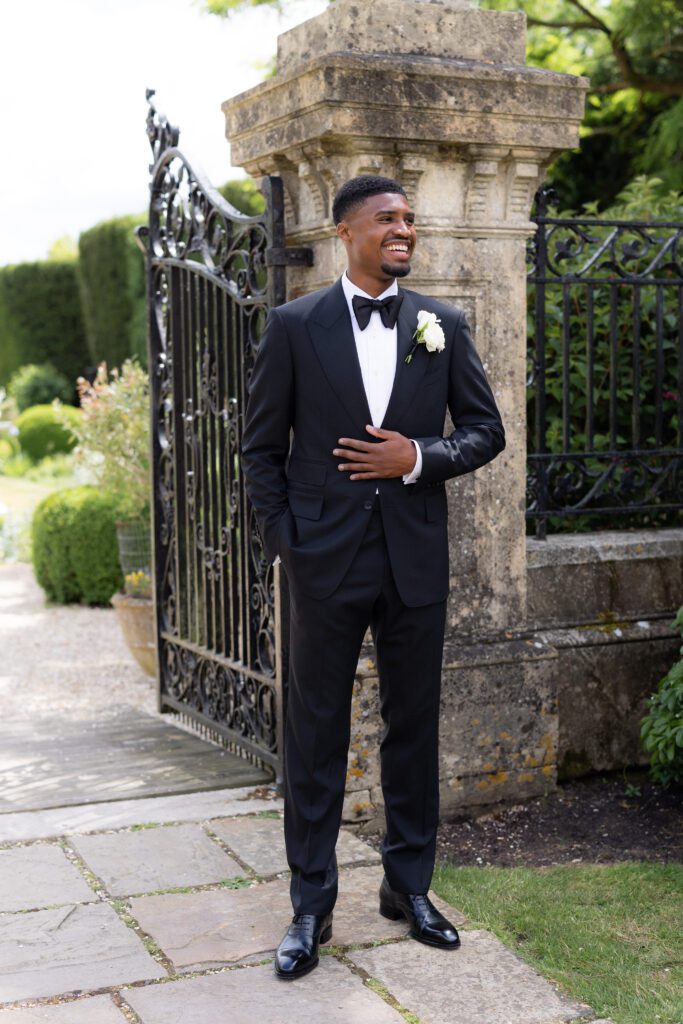 Handsome groom in walled garden Four Seaons Hampshire